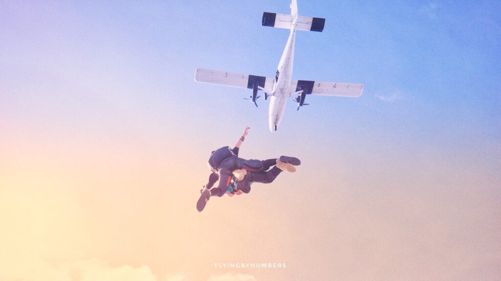 Tandem skydivers parachuting from a twin aircraft