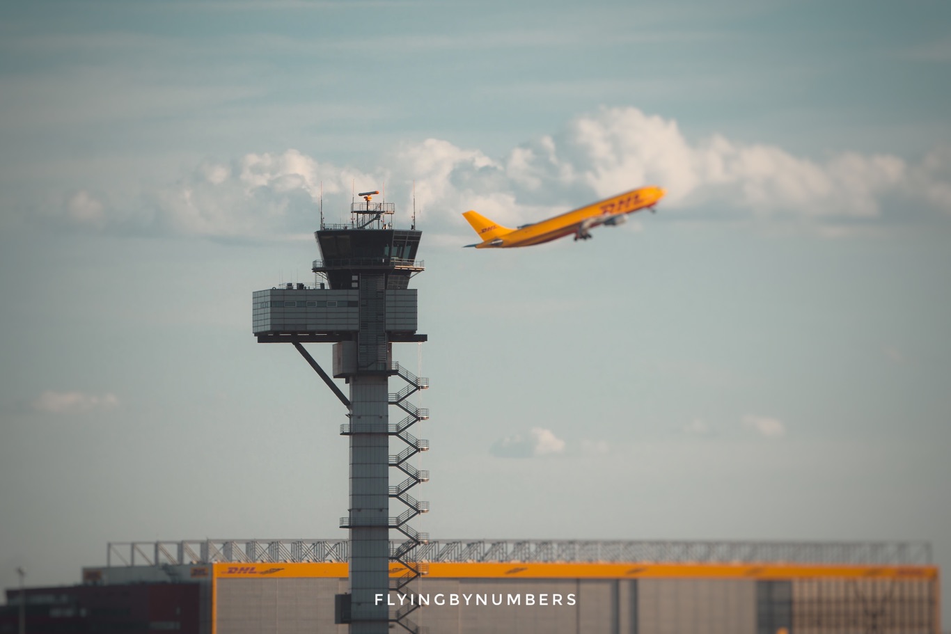 Air traffic control tower controlling departing DHL aircraft