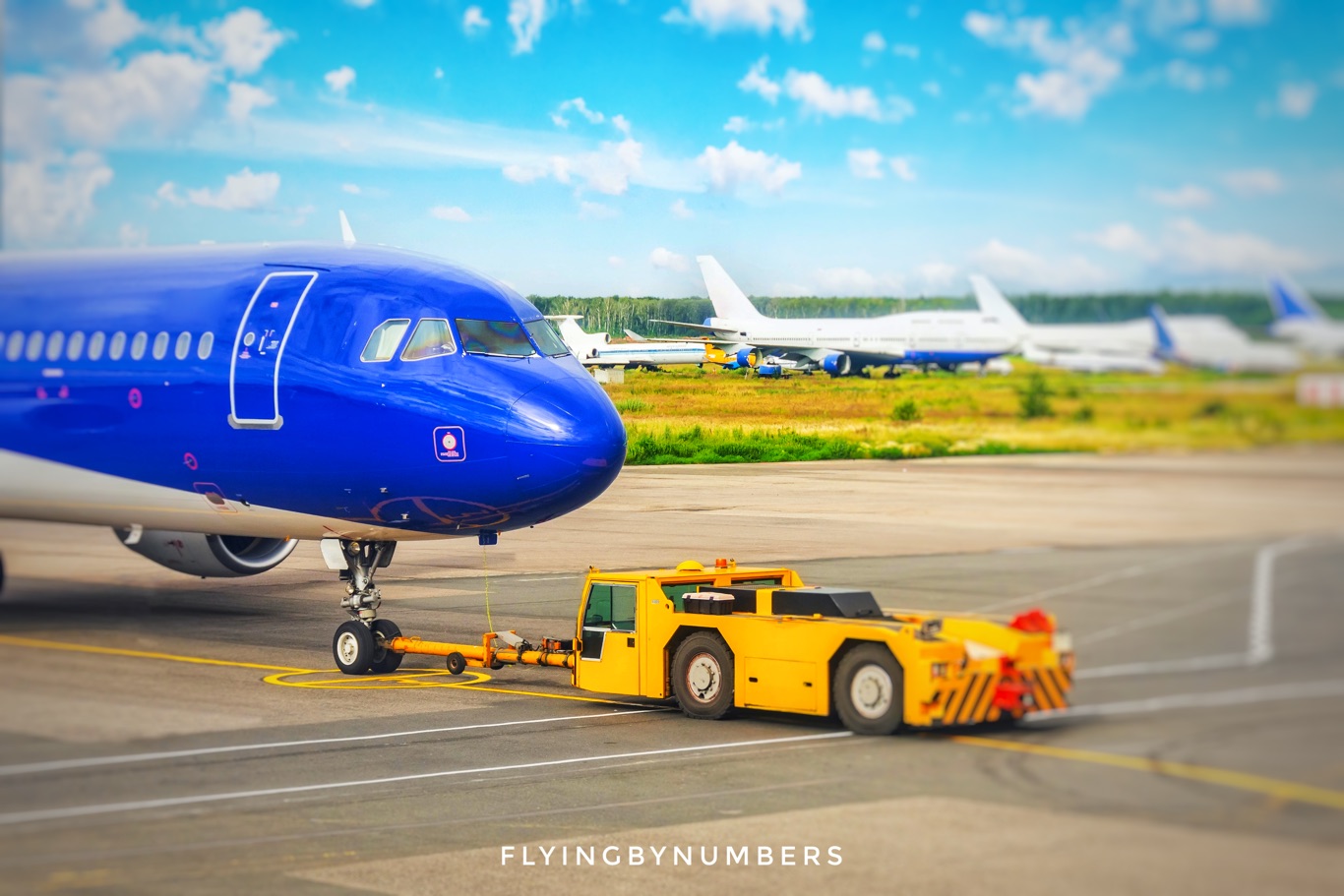 Pushback tug pushing an A320 back from its parking position