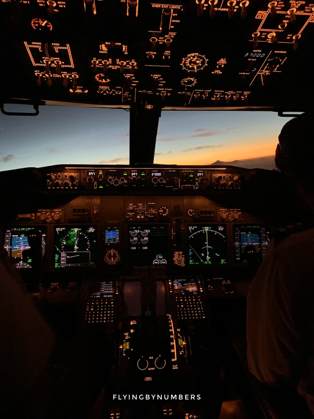 Commercial airliner cockpit at sunset