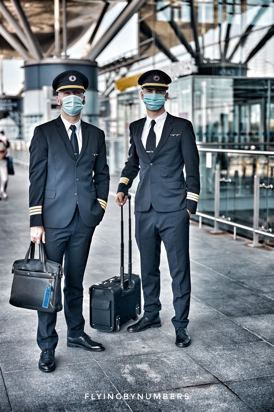 Two airline pilots wear masks during covid-19 downturn