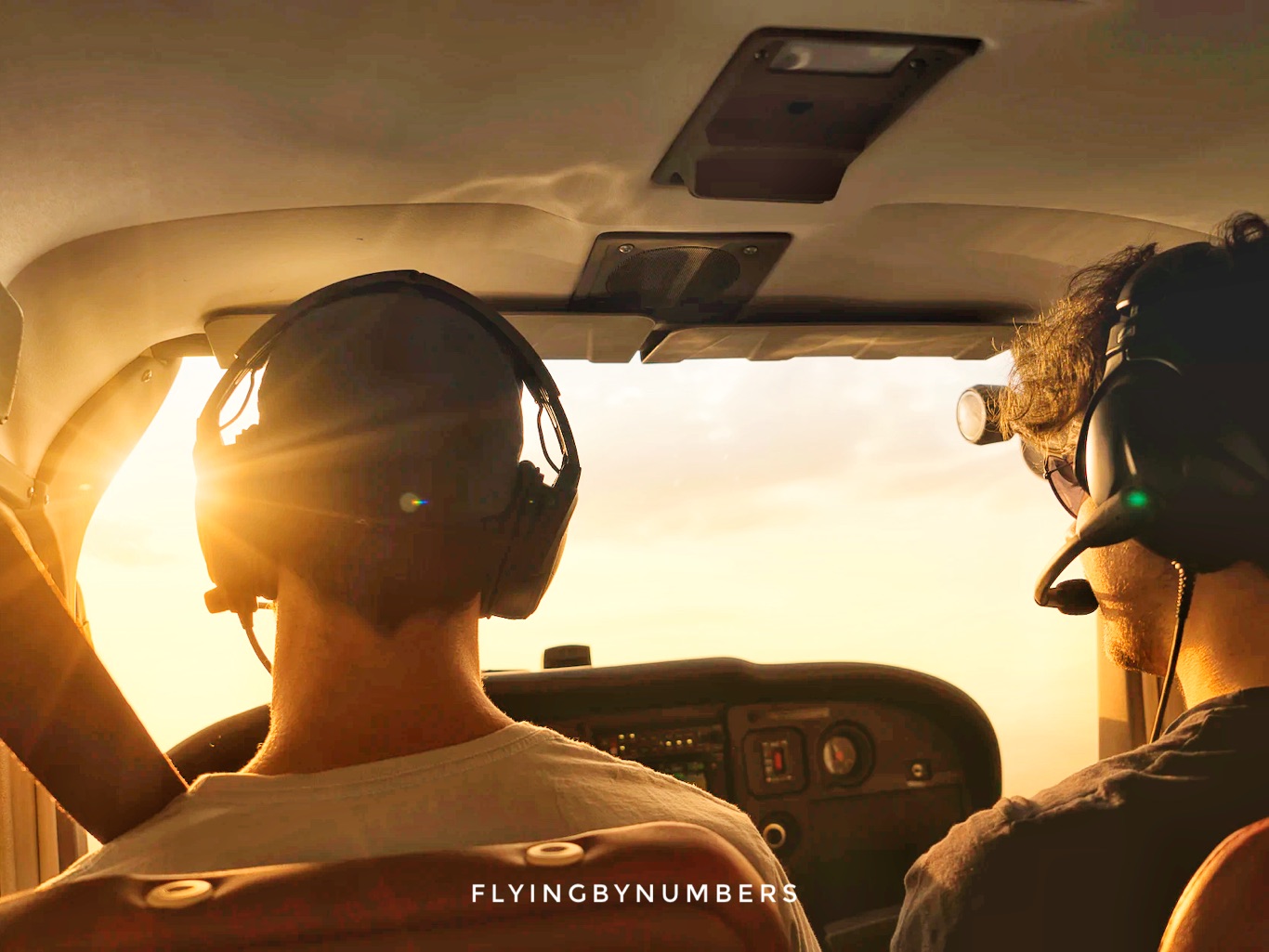 Two pilots flying into the sunlight
