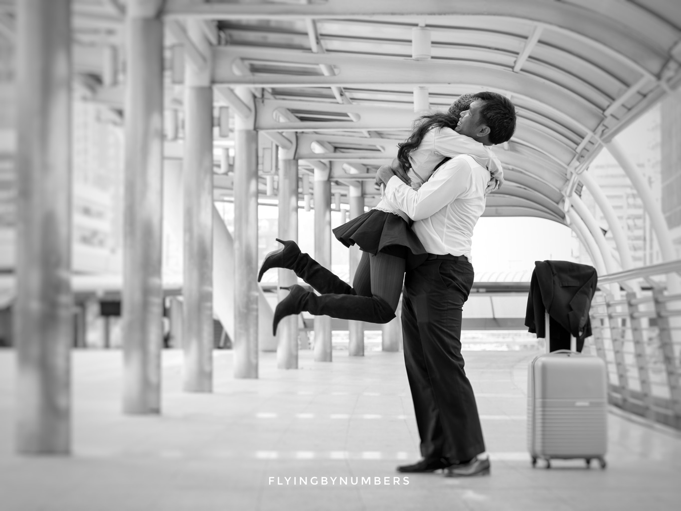 Couple embrace each other at airport