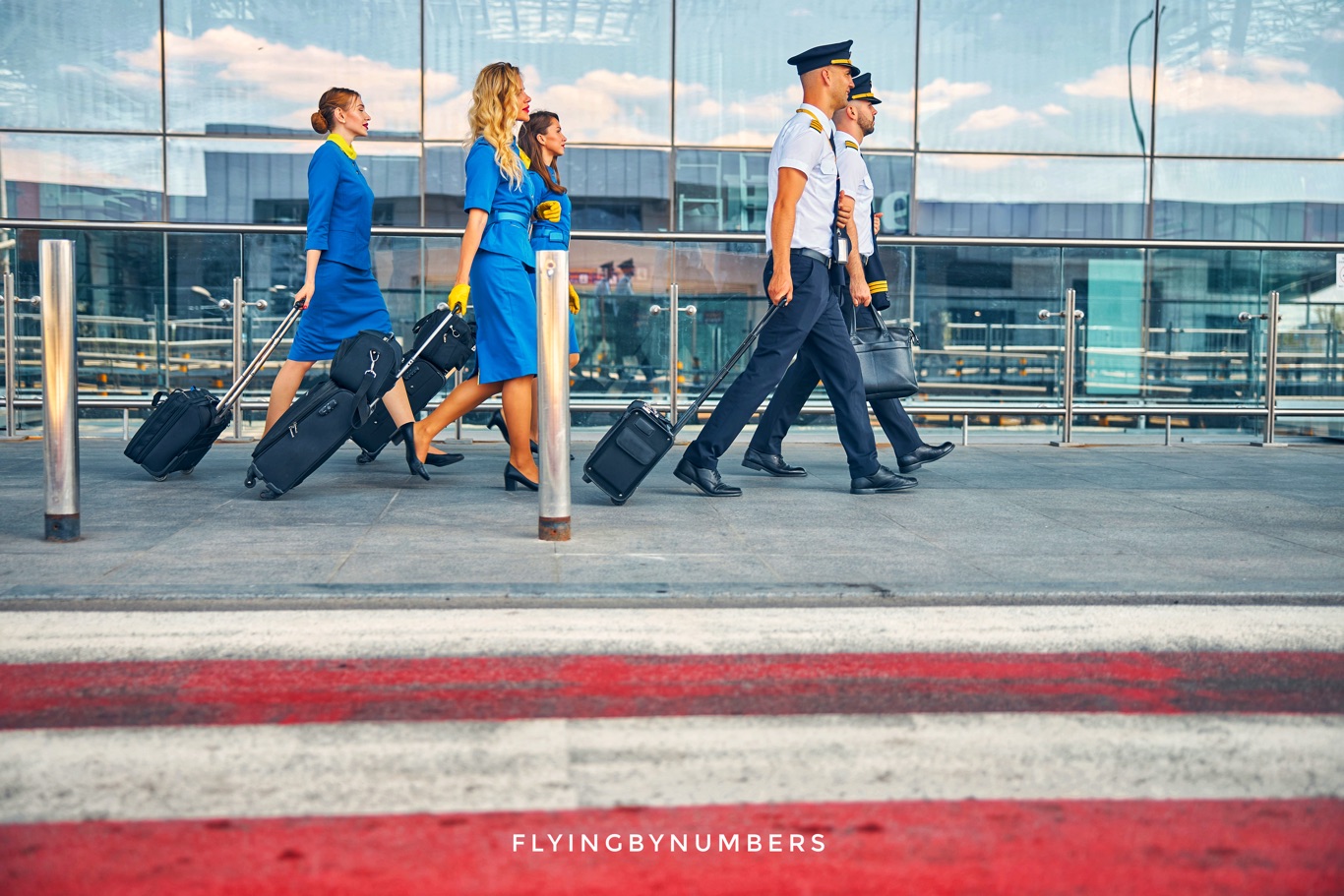 Pilots and flight attendants walking outside airport