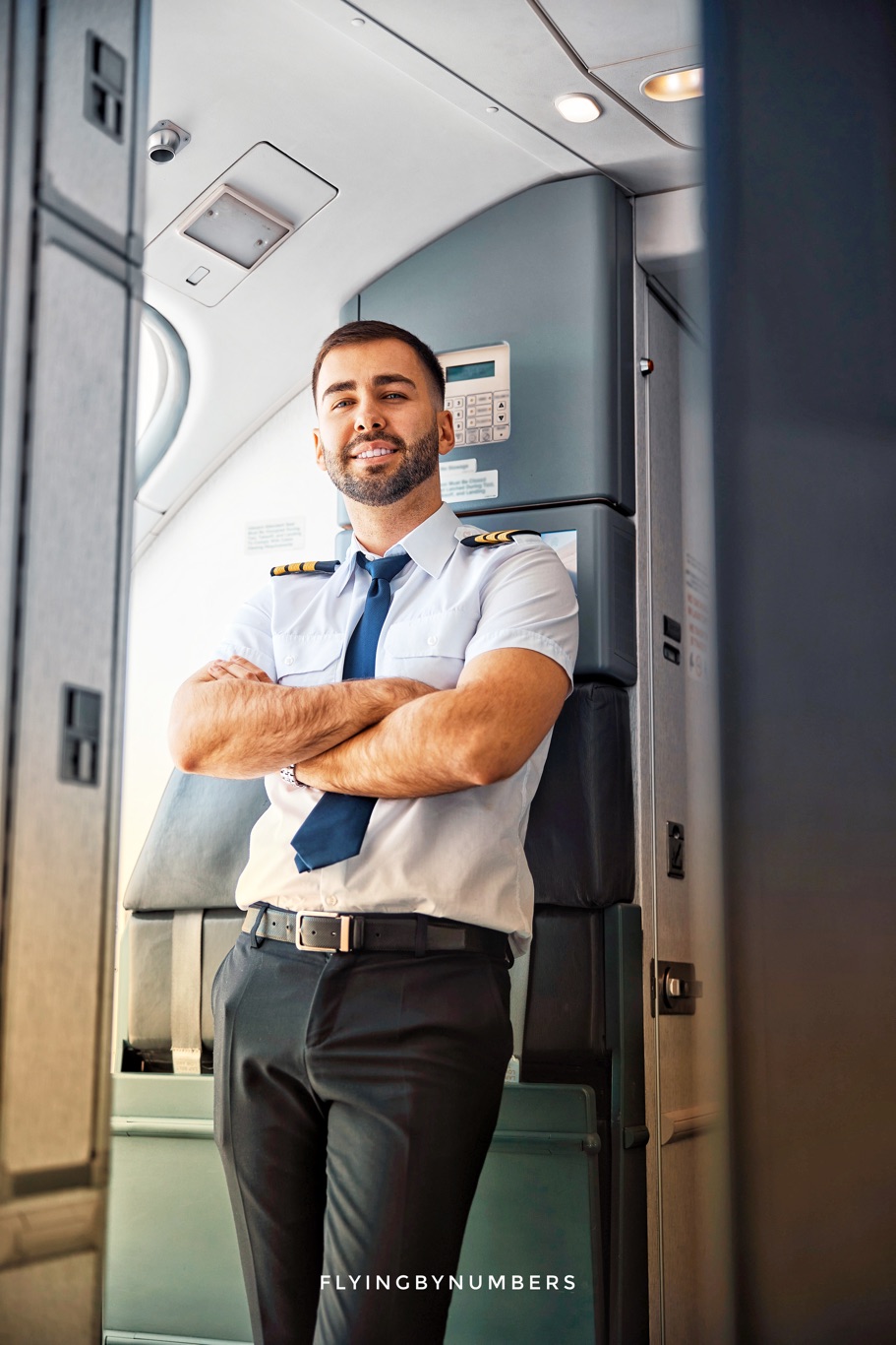 Commercial airline pilot stands at the front left door of a Boeing 737